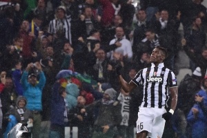 Juventus French midfielder Paul Labile Pogba celebrates after scoring during the Champions League Group A football match Juventus vs Olympiacos during the UEFA Champions League Group A football match Juventus vs Olympiakos at the Juventus Stadium in Turin on November 4, 2014. AFP PHOTO / GIUSEPPE CACACE (Photo credit should read GIUSEPPE CACACE/AFP/Getty Images)